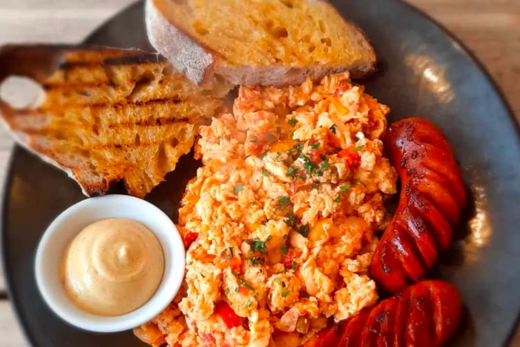 hungarian breakfast with toast, eggs, and sausage