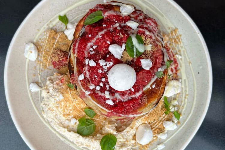 pancakes topped with red berries and mascarpone