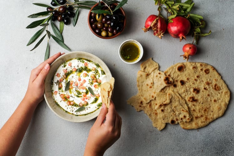 labneh cheese dip with flatbread and olives