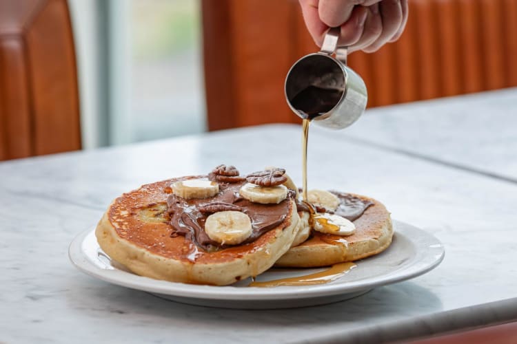 chocolate and banana pancakes drizzled with syrup