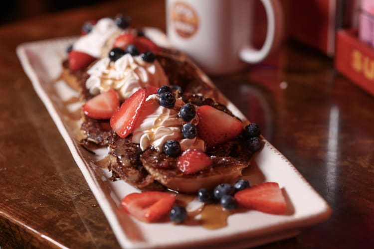 french toast topped with berries 