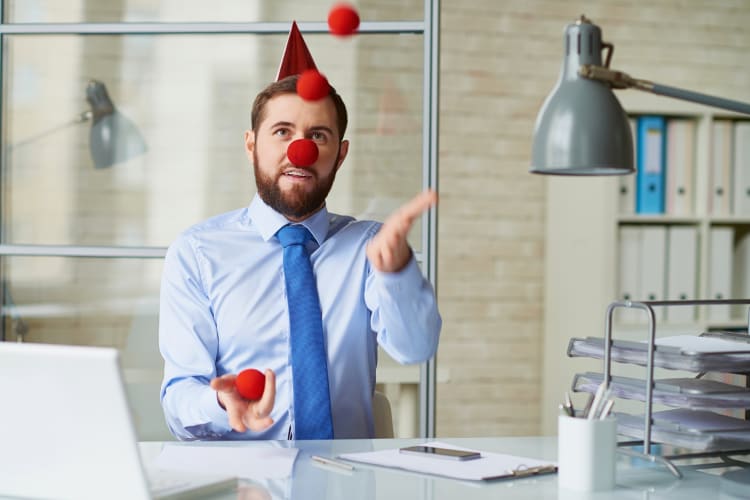 A man juggling balls in his office during a team building activity in Los Angeles