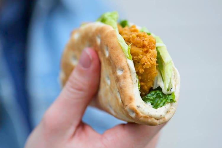 A flatbread taco with fried chicken, mayonnaise and lettuce
