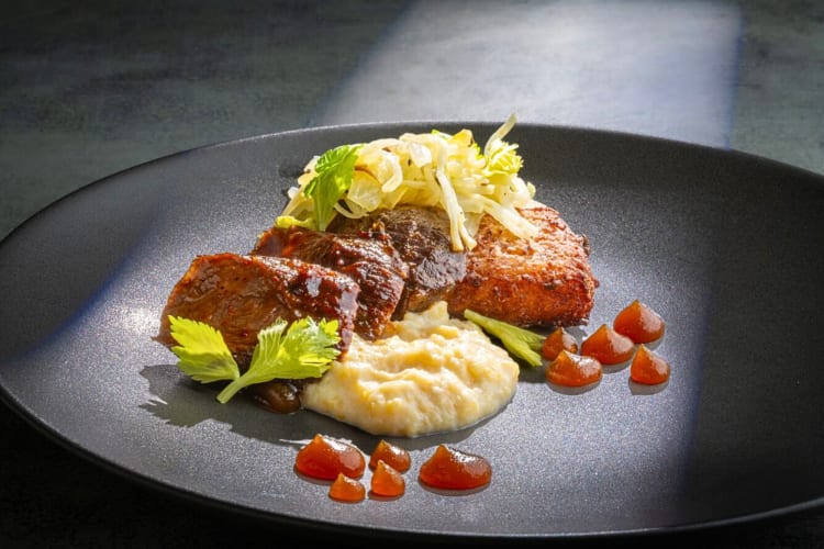 Meal from KIN, a Boise restaurant, with meat, mashed potato, onions and sauce