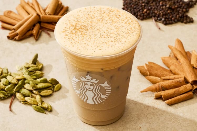 A Starbucks chai latte surrounded by spices