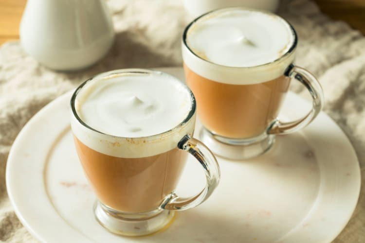 Two glass mugs with London Fog drinks in them