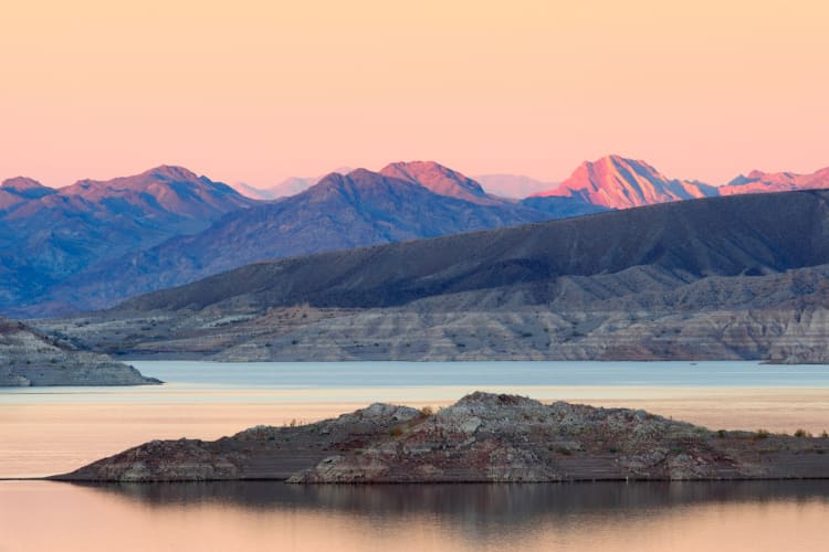 A lake and mountains at sunset