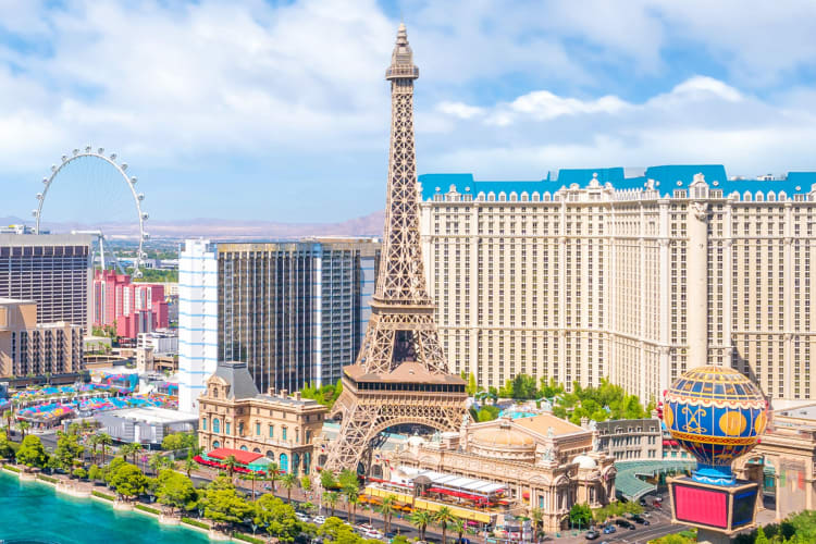 An Eiffel Tower replica next to other buildings and a body of water