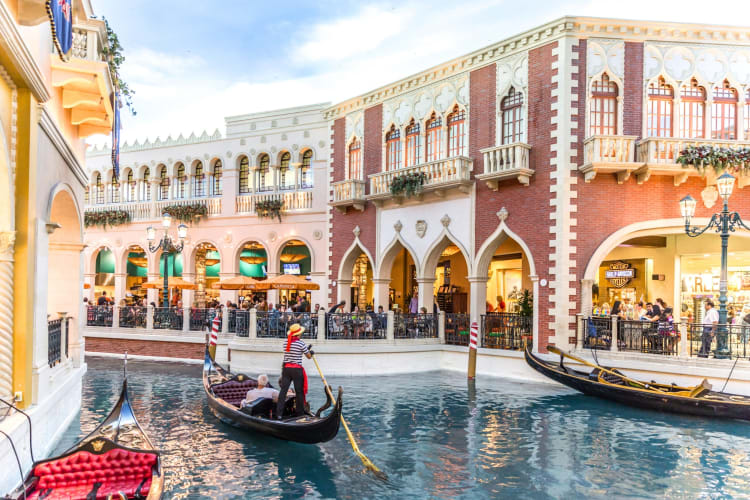 A gondola on the water next to buildings