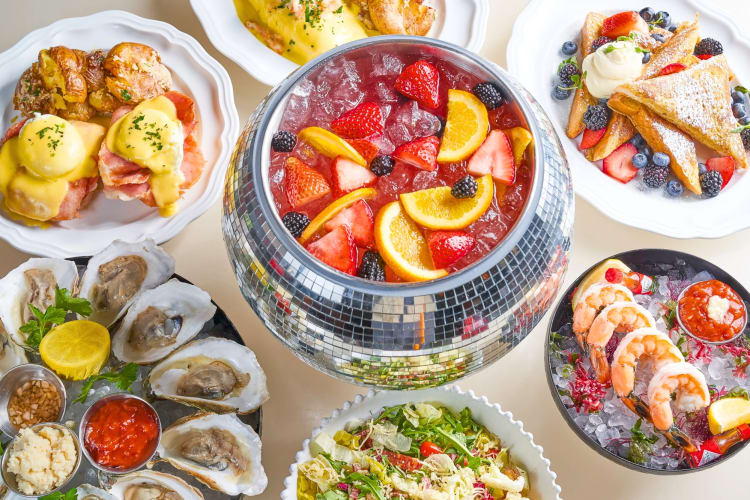 A disco ball punch bowl surrounded by brunch dishes