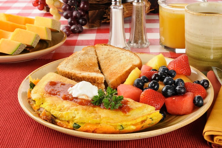 Breakfast meal with an omelette, toast and fresh fruit