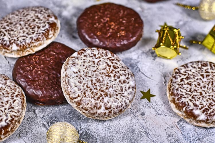 Lebkuchen, a German Christmas food, on a powdered wooden surface