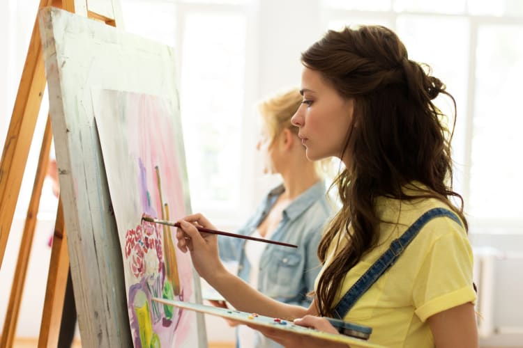 A woman painting on a canvas