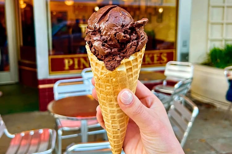 Close-up of a person's hand holding an ice cream cone