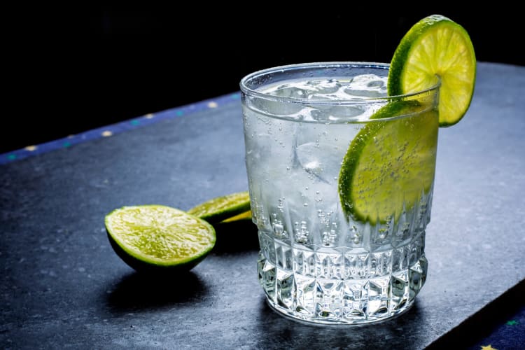 A glass of sparkling water with fresh lime 