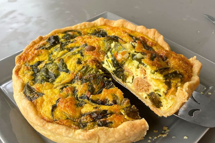 Slice of quiche being taken from the rest of the pie at Looking Meadow Café