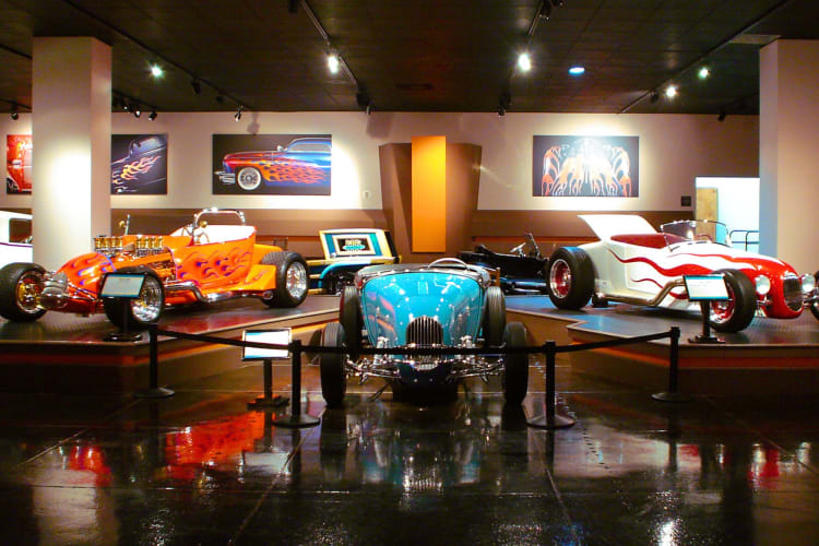 Three vintage cars in a museum exhibit
