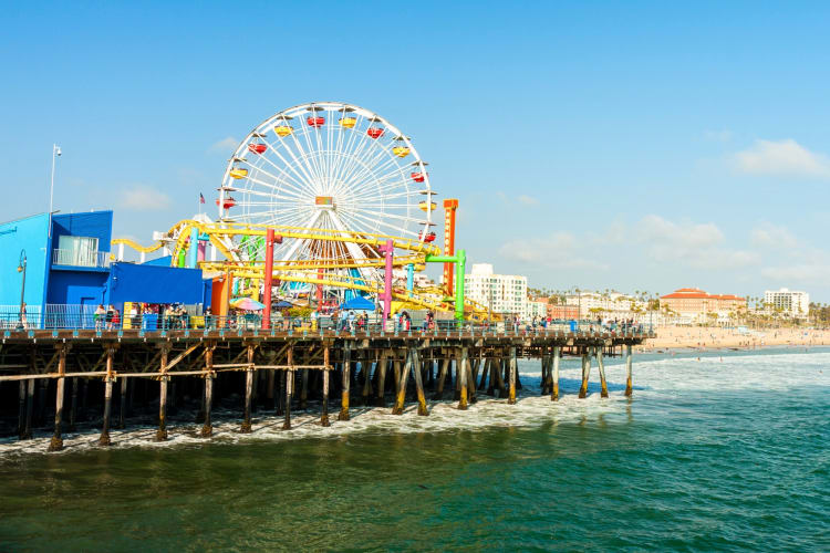 A Ferris wheel on a pier at the beach