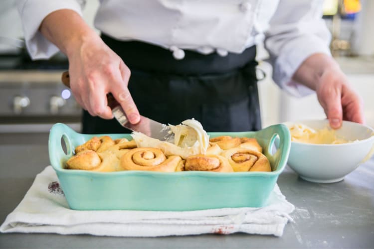 A chef making cinnamon rolls.