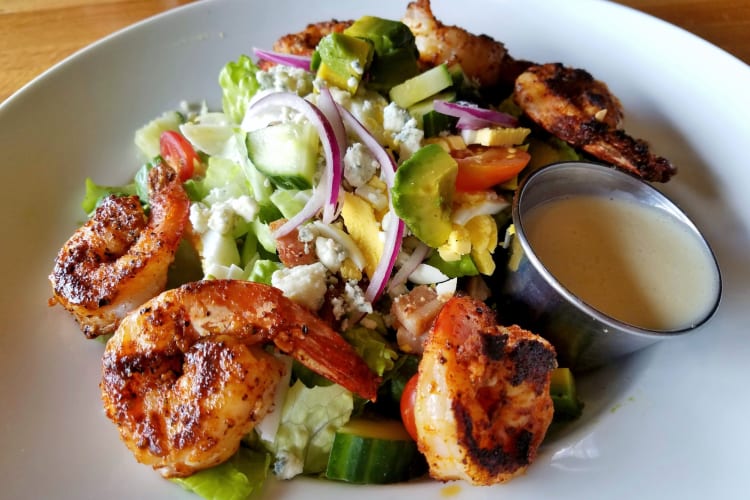 A salad with blackened shrimp