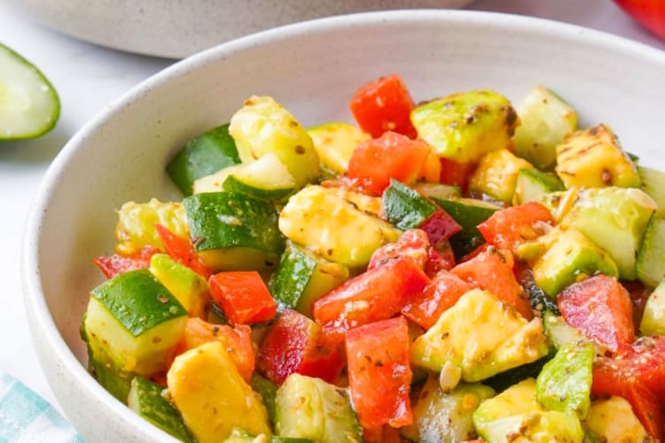A bowl of cucumber, avocado and tomato salad