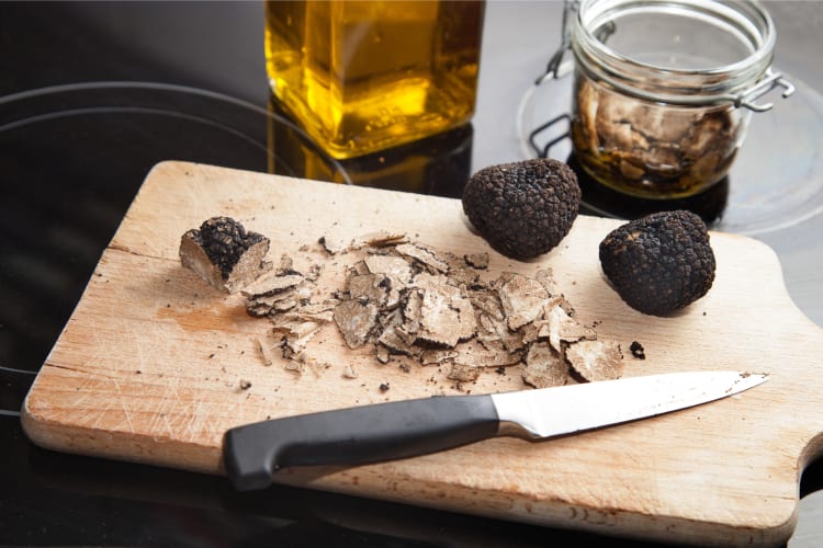 What are truffles? Bianchetto truffles on a chopping board 