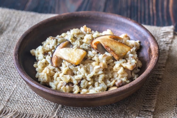 A wooden bowl with mushroom risotto