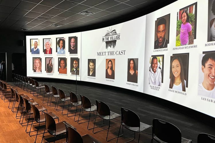 Chairs lined up in front of a large monitor at MODEx Studio, an event space in Atlanta