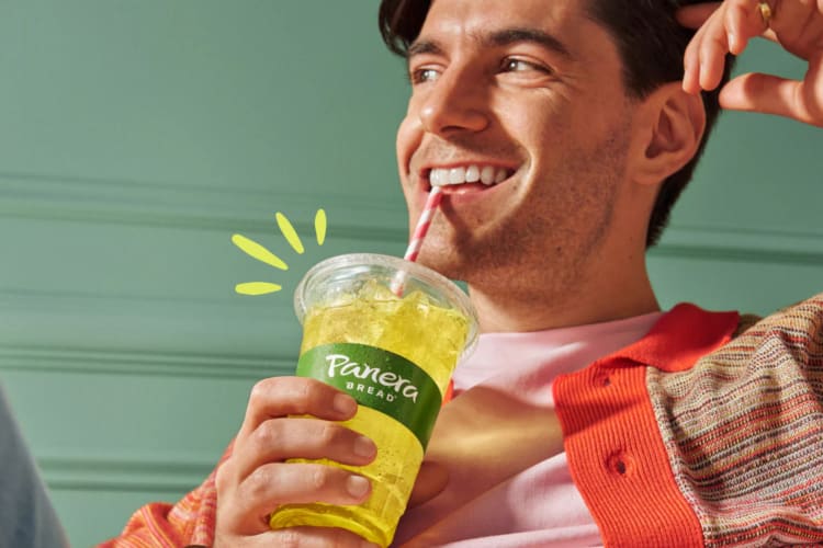Man drinking a drink from Panera