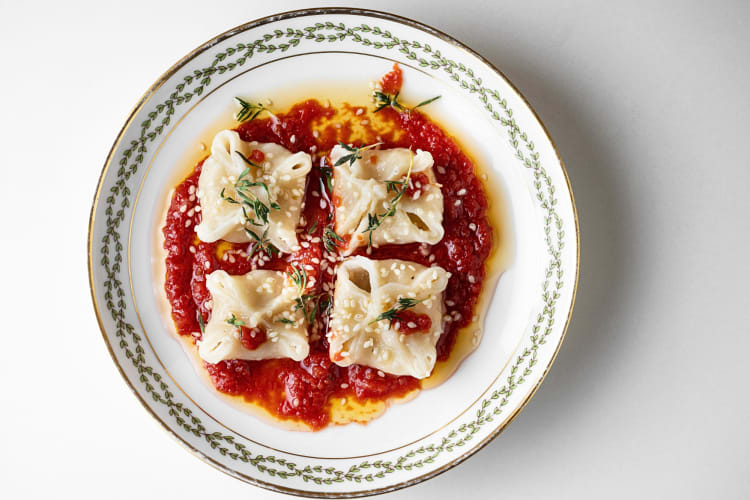 Aerial view of the Turkish food known as mantı (dumplings) served with red sauce