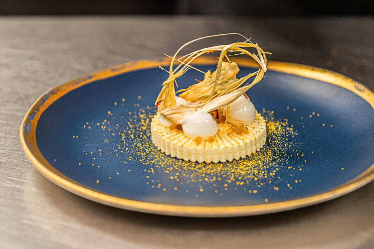 Gourmet tasting meal on a blue plate from March, a restaurant in Houston