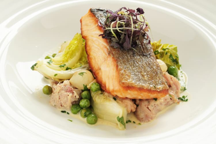 Portion of sea bream on a bed of greens