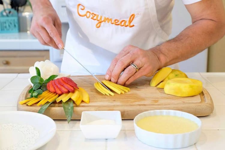 A person cutting tropical fruit