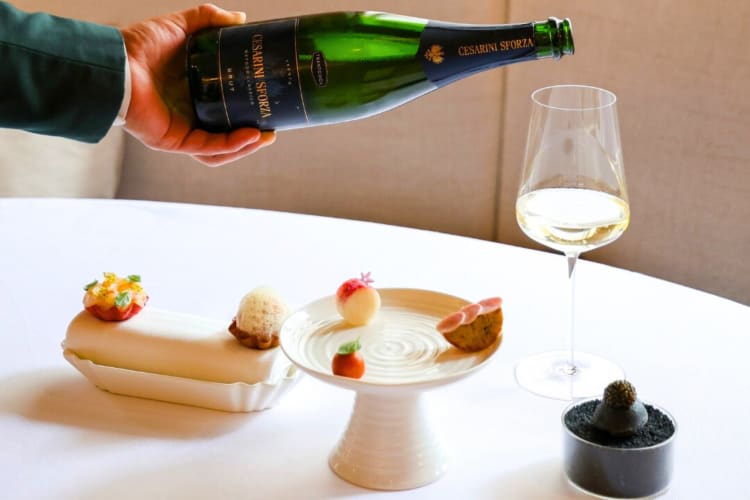 High end desserts and a person pouring Champagne into a glass