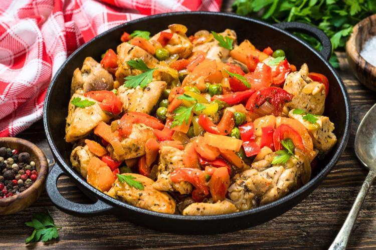 Chicken with vegetables in a black pot