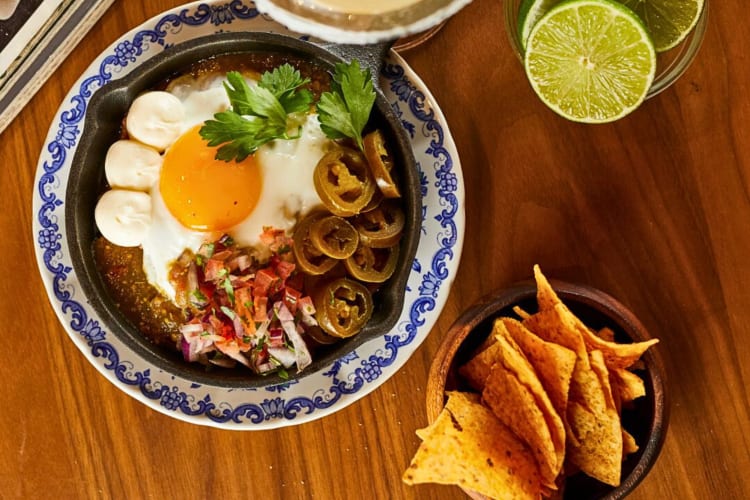 Aerial shot of huevos rancheros and chips from Milk Bar & Bistro