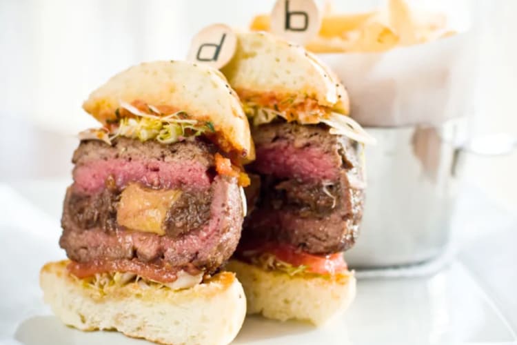 A burger cut in half on a plate