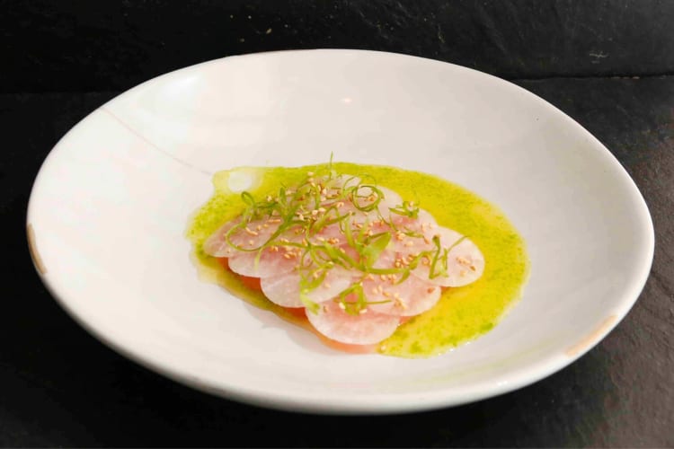 A albagore tuna crudo dish with green consomme