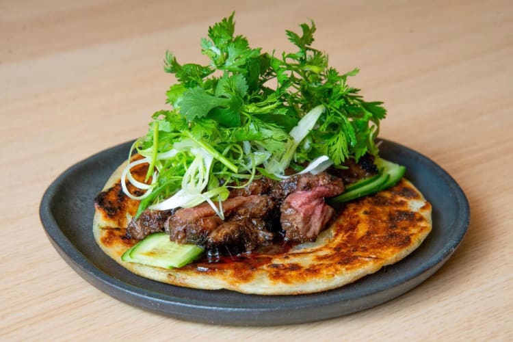 Steak and cilantro on a scallion wrap