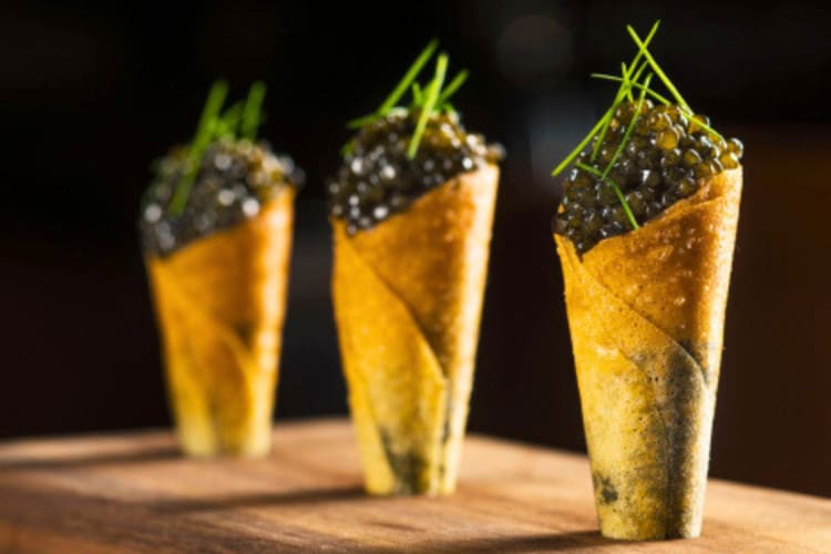 Caviar in cones with a green garnish