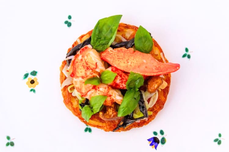 Lobster in a white bowl with painted flowers