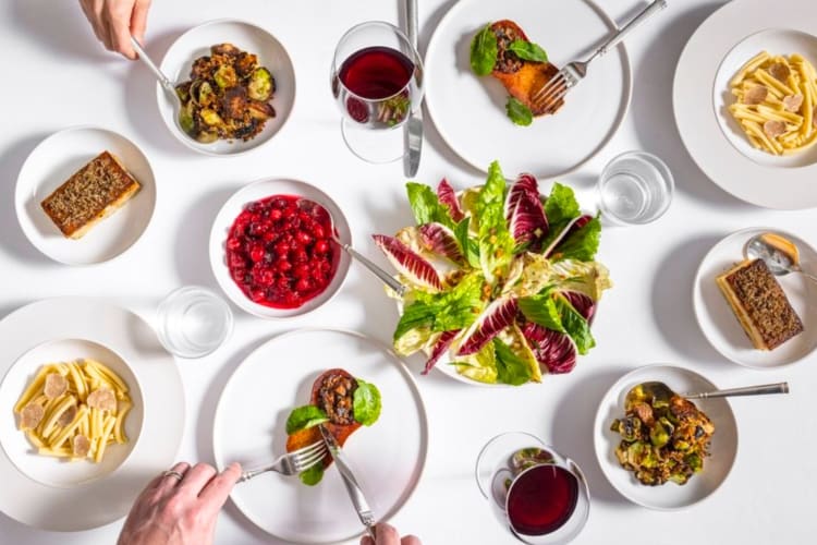 A selection of dishes on a table with a white table cloth