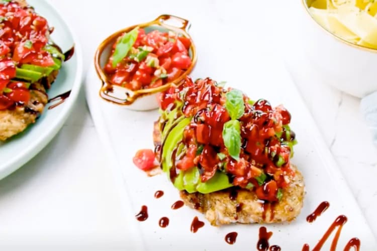 Chicken topped with chopped tomatoes and basil