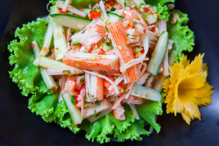 A crab stick and cucumber salad on a lettuce leaf