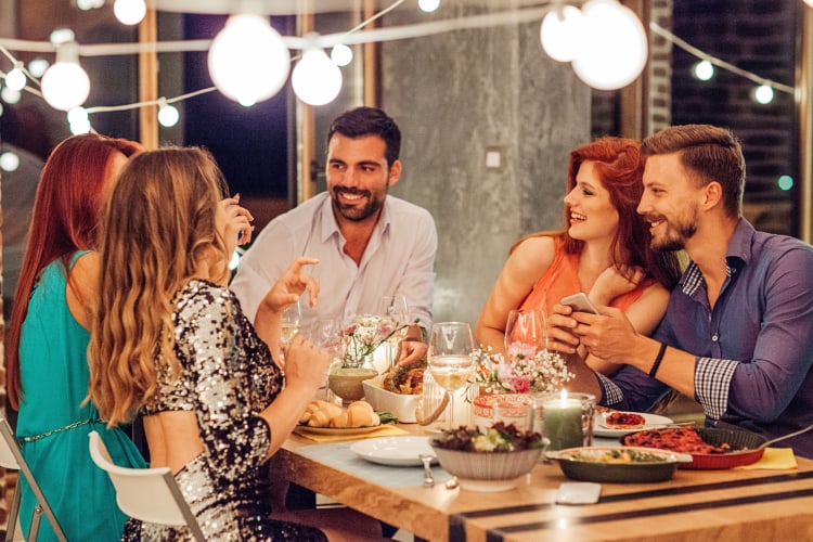 Five friends chatting at a dinner party