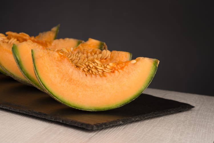 Cut cantaloupe melon on a board