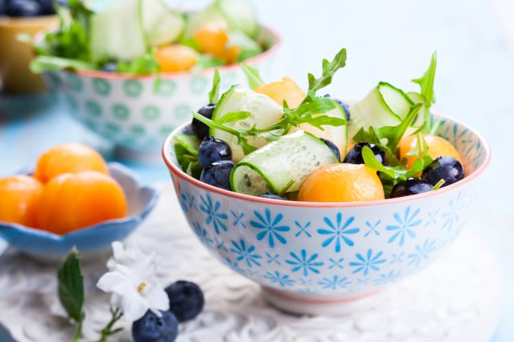 A patterned bowl with muskmelon salad