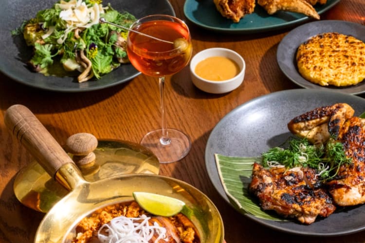 Thai dishes and cocktails on a table