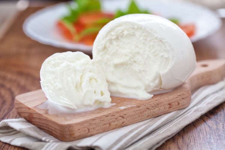 A ball of buffalo mozzarella on a board
