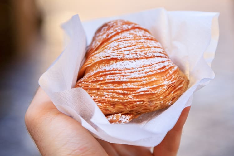 Sfogliatella is a traditional Naples food often eaten for breakfast